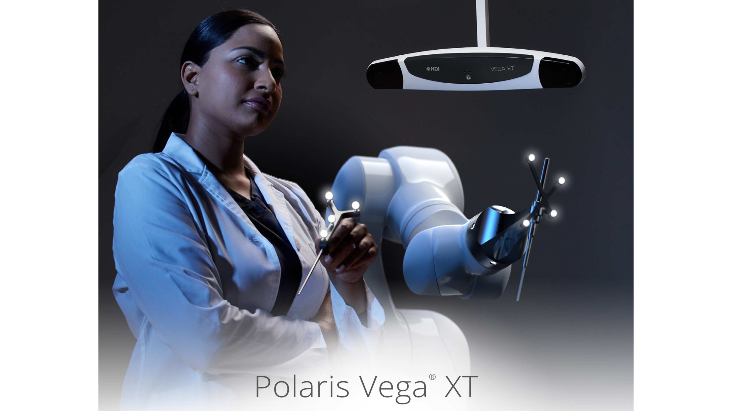 A woman has rigid body with spheres in her hand, in the background a robot and the camera